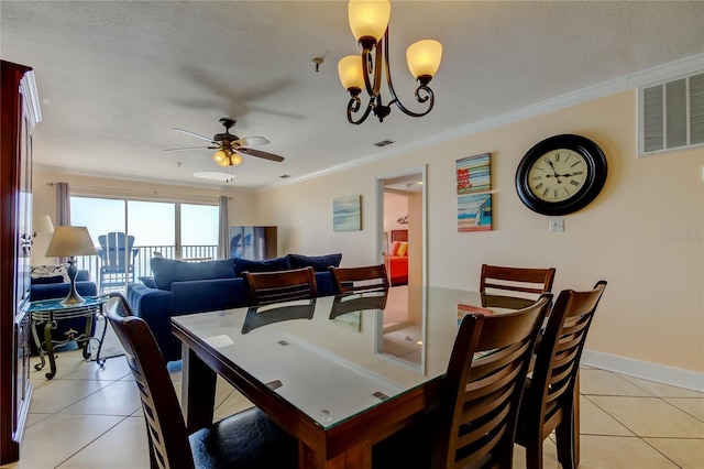 tiled dining area featuring crown molding, ceiling fan with notable chandelier, and a textured ceiling