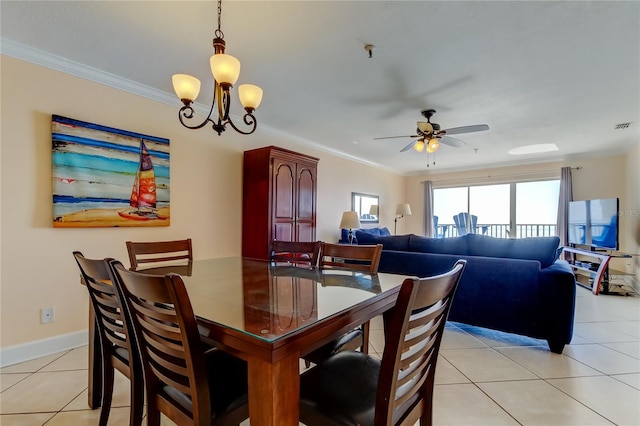 dining area with crown molding, ceiling fan with notable chandelier, and light tile patterned floors