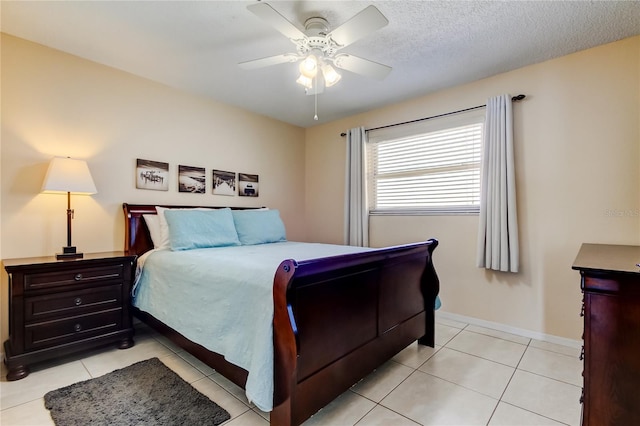 tiled bedroom featuring a textured ceiling and ceiling fan