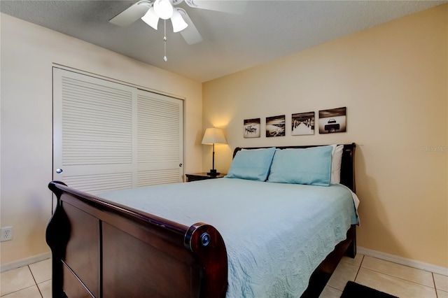 tiled bedroom featuring ceiling fan and a closet