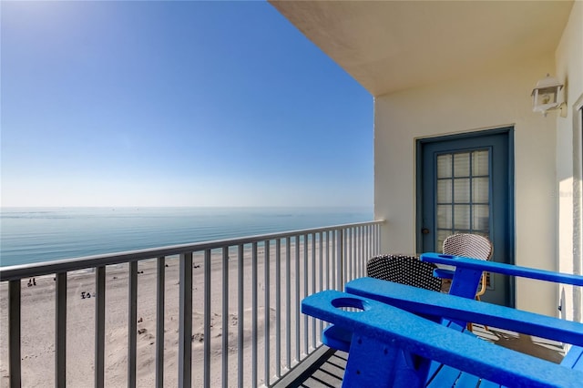 balcony with a water view and a beach view