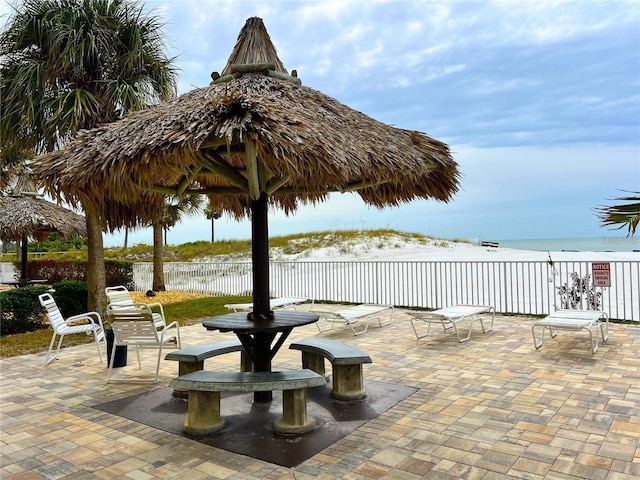 view of patio with a view of the beach and a water view