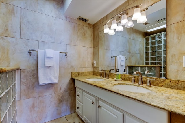 bathroom with tile patterned floors, tile walls, and vanity