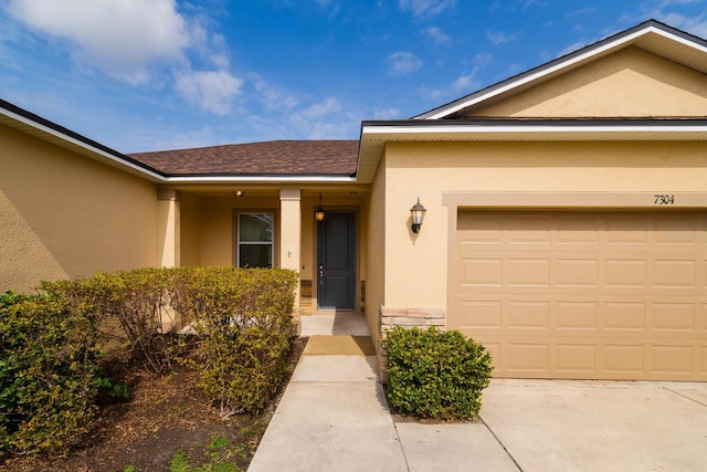 doorway to property with a garage