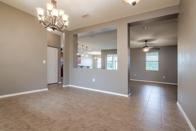 spare room with light tile patterned floors and ceiling fan with notable chandelier