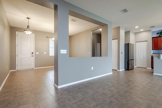 unfurnished living room with light tile patterned floors