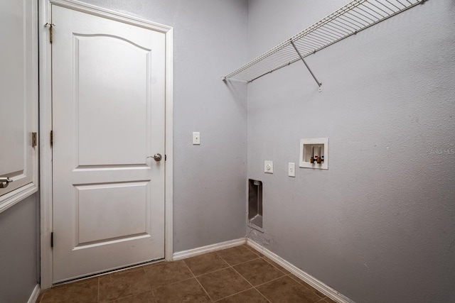 clothes washing area with washer hookup, dark tile patterned flooring, and electric dryer hookup