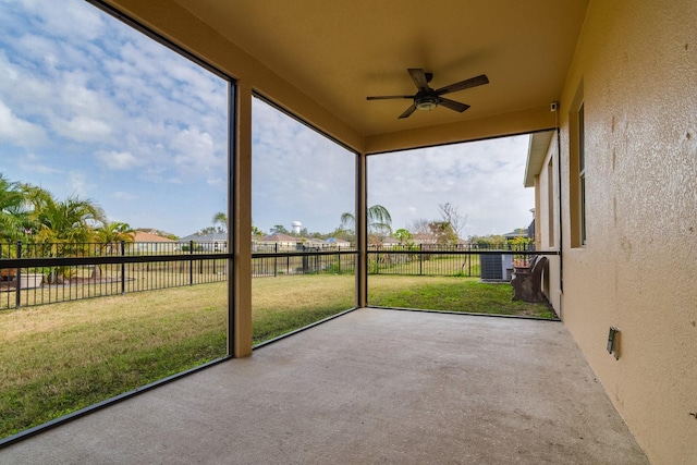 unfurnished sunroom featuring ceiling fan