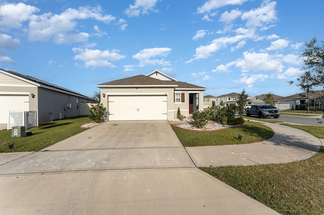 single story home with a garage and a front lawn