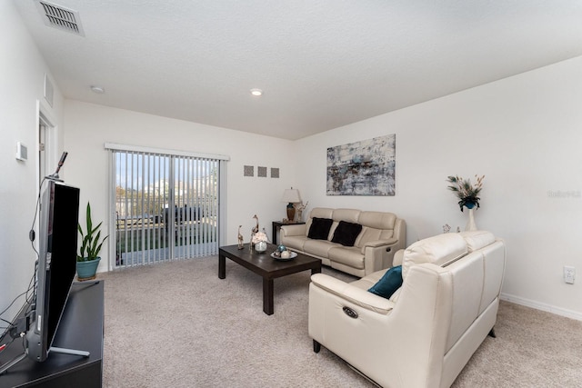 carpeted living room featuring a textured ceiling