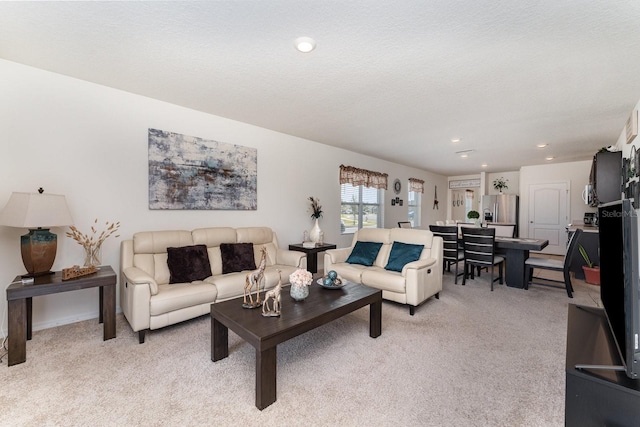 living room featuring light carpet and a textured ceiling