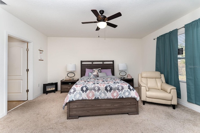 bedroom with light carpet, a textured ceiling, and ceiling fan