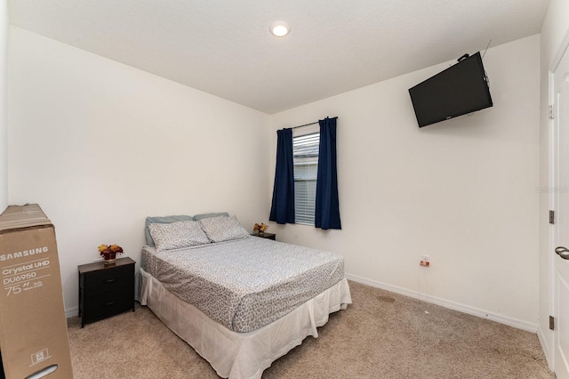 bedroom featuring light carpet