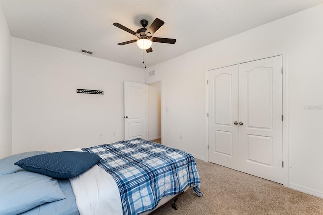 bedroom with light carpet, a closet, and ceiling fan