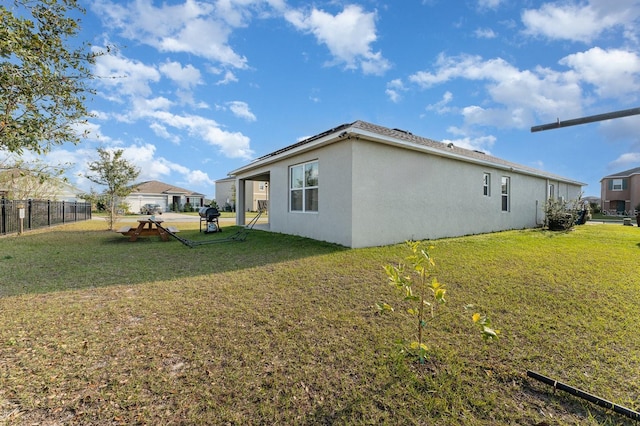 view of side of home with a lawn