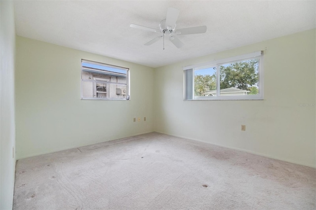 unfurnished room with light carpet and ceiling fan