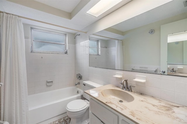 full bathroom with toilet, tile walls, vanity, shower / bath combo, and decorative backsplash