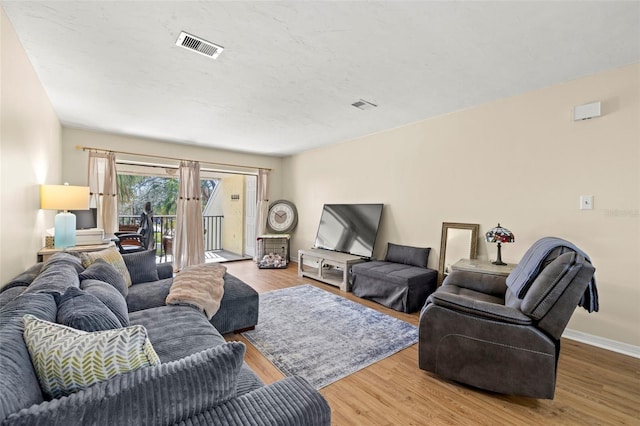 living room with hardwood / wood-style floors and french doors