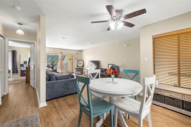 dining area with ceiling fan and light hardwood / wood-style flooring