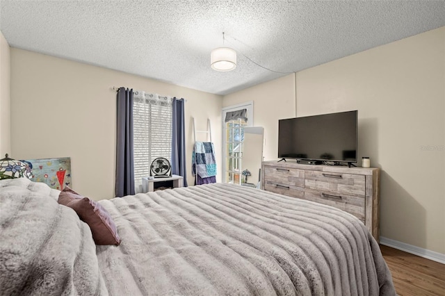 bedroom featuring hardwood / wood-style floors and a textured ceiling