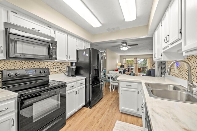 7300 Sunshine Skyway Ln S Unit 202, Saint Petersburg, FL 33711 - kitchen featuring black appliances, white cabinets, and light countertops