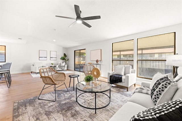 living room featuring vaulted ceiling, ceiling fan, and hardwood / wood-style floors