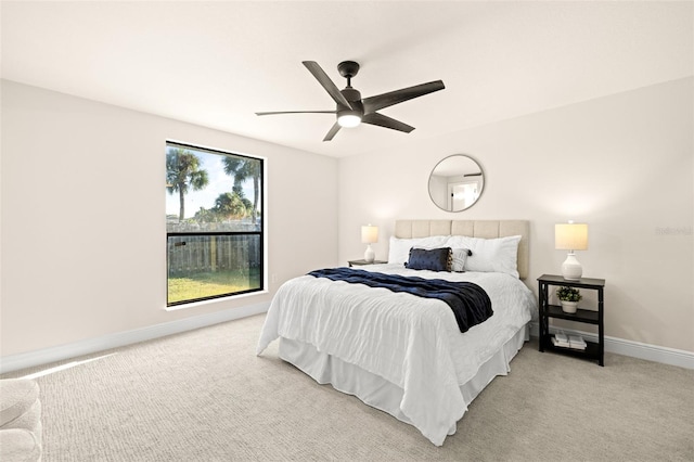 bedroom with light carpet and ceiling fan