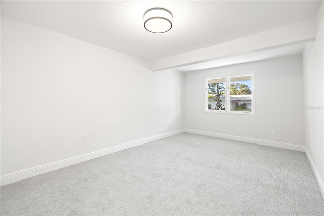 empty room featuring carpet floors and a textured ceiling