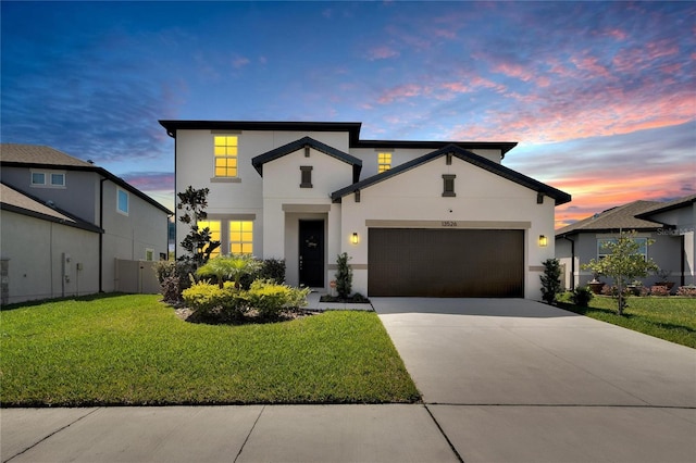 view of front of house with a yard and a garage