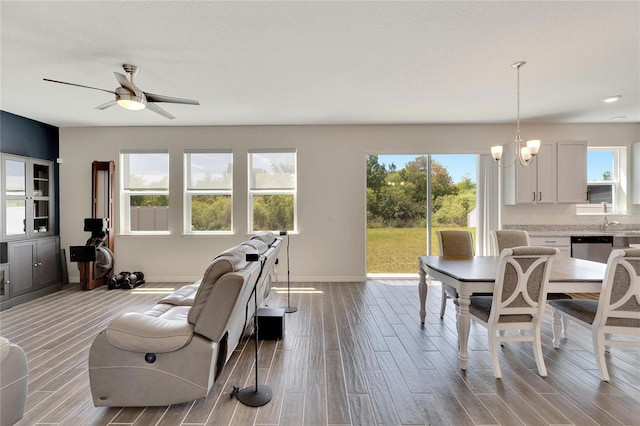 interior space featuring ceiling fan with notable chandelier