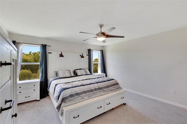 bedroom featuring ceiling fan and light carpet