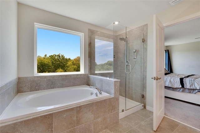 bathroom with tile patterned floors and separate shower and tub