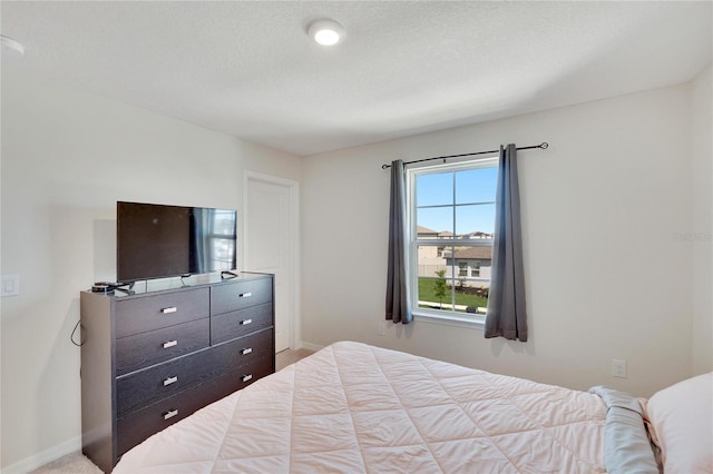 carpeted bedroom with a textured ceiling