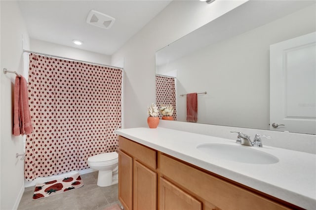 bathroom with vanity, tile patterned floors, toilet, and walk in shower