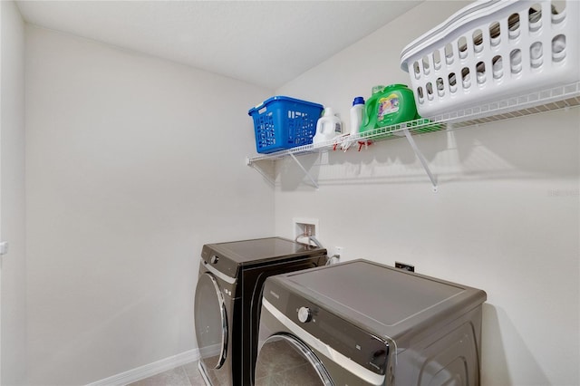 washroom featuring washer and dryer and tile patterned floors