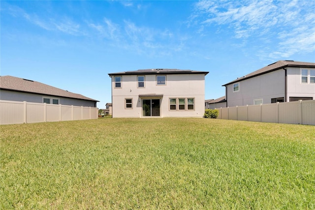 back of property featuring a lawn