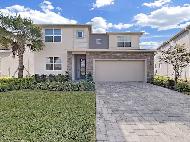 view of front of property with a garage and a front lawn