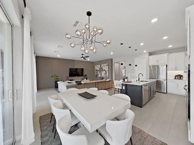 dining area featuring sink and a chandelier