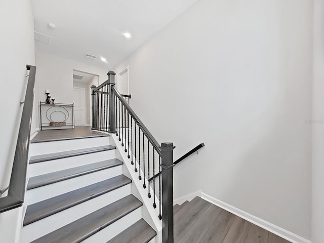 stairway with hardwood / wood-style flooring