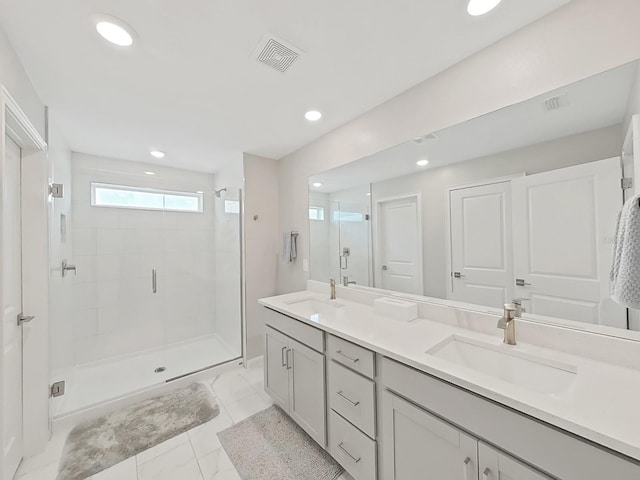 bathroom with vanity and a shower with shower door