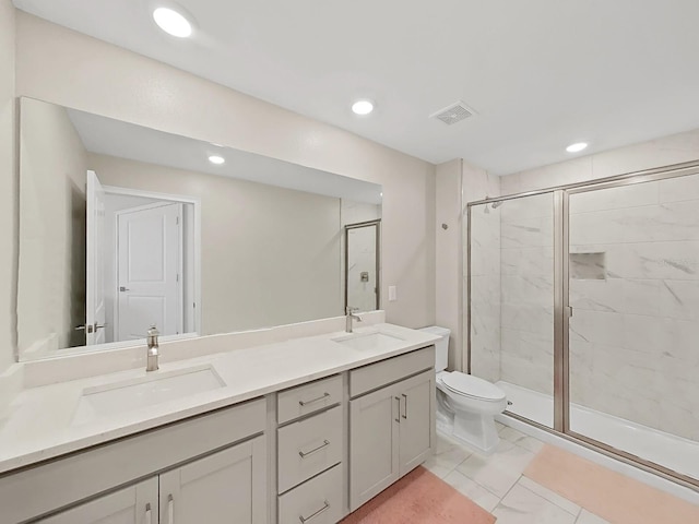 bathroom featuring vanity, toilet, and a shower with door