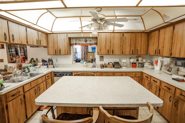 kitchen with sink, ceiling fan, dishwasher, light tile patterned flooring, and kitchen peninsula