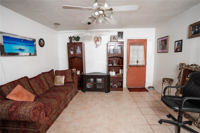 tiled living room featuring ceiling fan and a textured ceiling