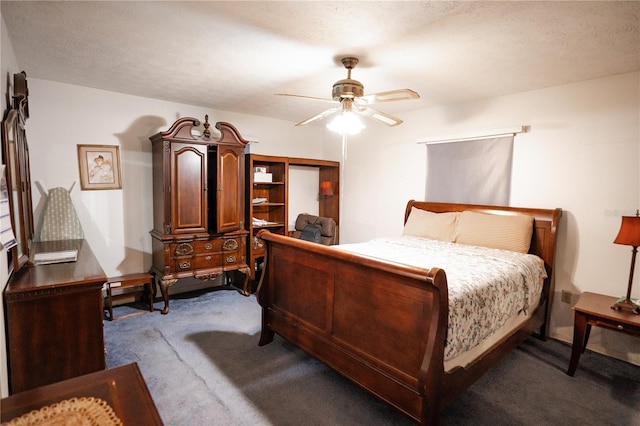 carpeted bedroom with ceiling fan and a textured ceiling