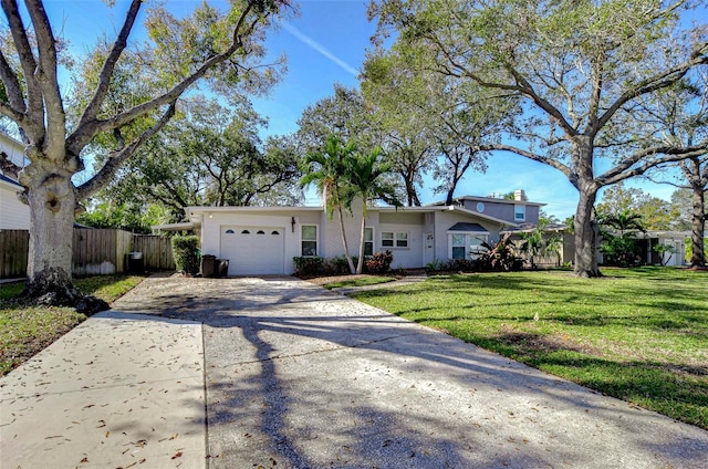 single story home featuring a garage and a front yard