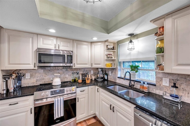 kitchen with stainless steel appliances, sink, and white cabinets