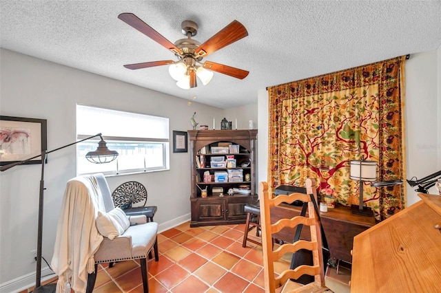 office area featuring light tile patterned flooring, ceiling fan, and a textured ceiling