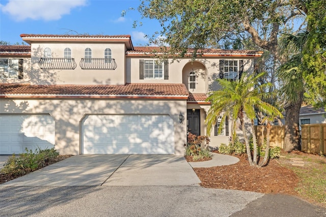 mediterranean / spanish-style house with a garage