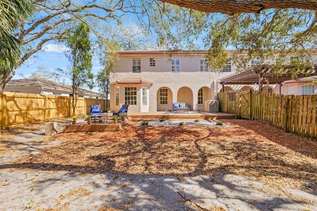 back of property with a deck and a pergola