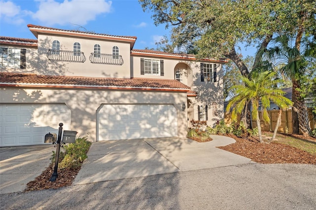 mediterranean / spanish home with a garage